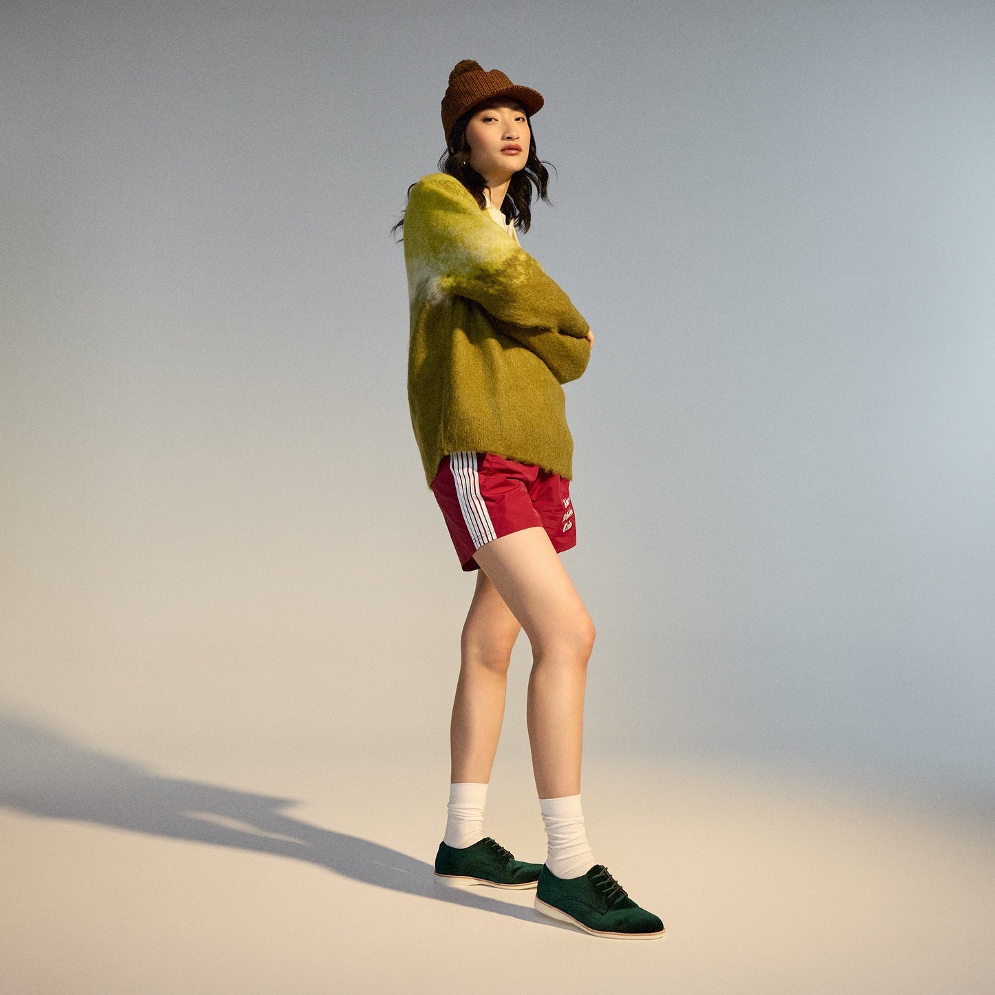 Side view of a person in casual wear, showing Rollie Womens Derby Emerald Green Velvet Brogue Shoes: lace-up, soft sole.  ksnz, 9339554068114, 9339554005690, 9339554000077, 9339554000336, 9339554023830