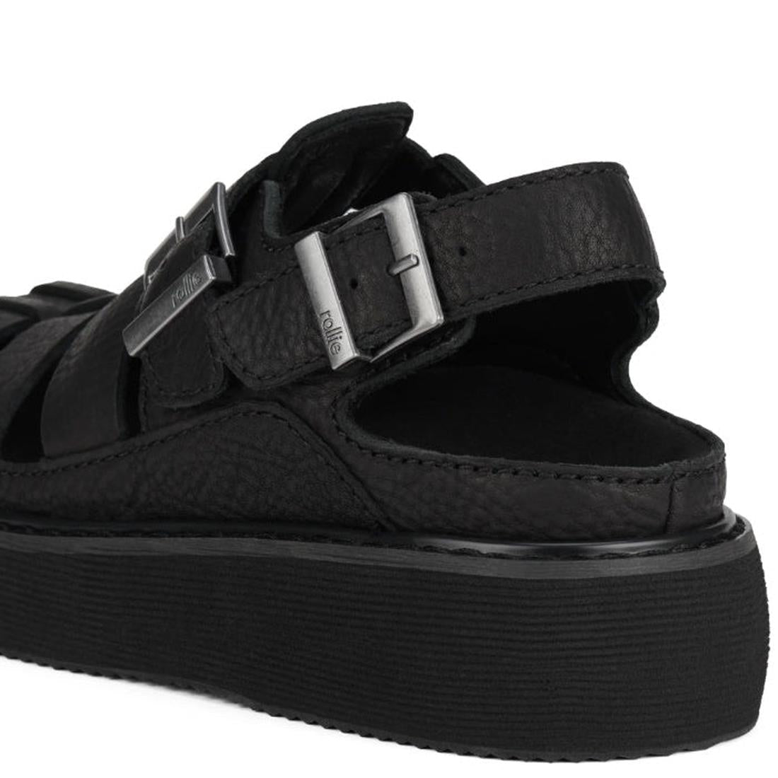 Heel view showing back strap with buckle of Rollie Hyde Fisherman Black sandal with buckle detail on a white background.,
9781760788858,
9781760788865,
9781760788872,
9781760788889,
9781760788896,, 46056, 9781760788858, 9781760788865, 9781760788872, 97817