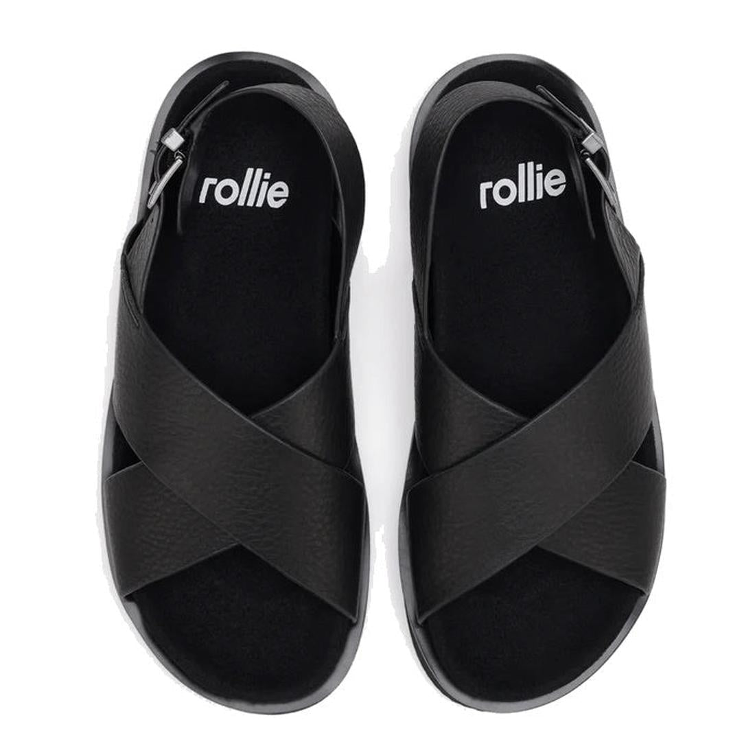 The Rollie Womens Rhodes Cross Sandal in tumble black leather features crisscross uppers, open toes, a back strap, and "rollie" printed in white on the insoles, shown from above on a white background., 48159, 9781760793692, 9781760793708, 9781760793715, 9