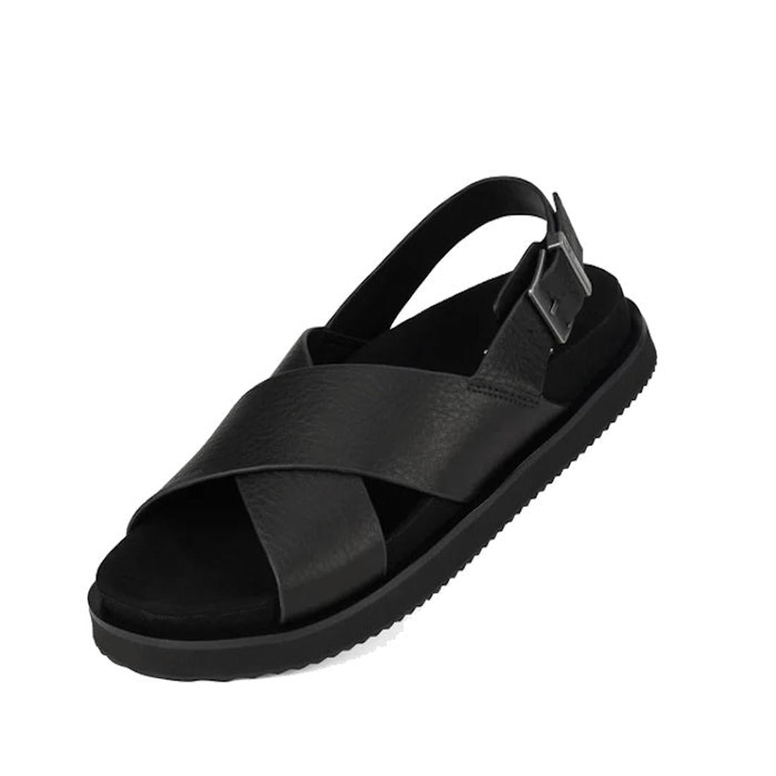 The Rollie Womens Rhodes Cross Sandal in Tumble Black Leather features crossed straps, an open toe, a slingback heel with metal buckle, and a flat ridged rubber sole.
