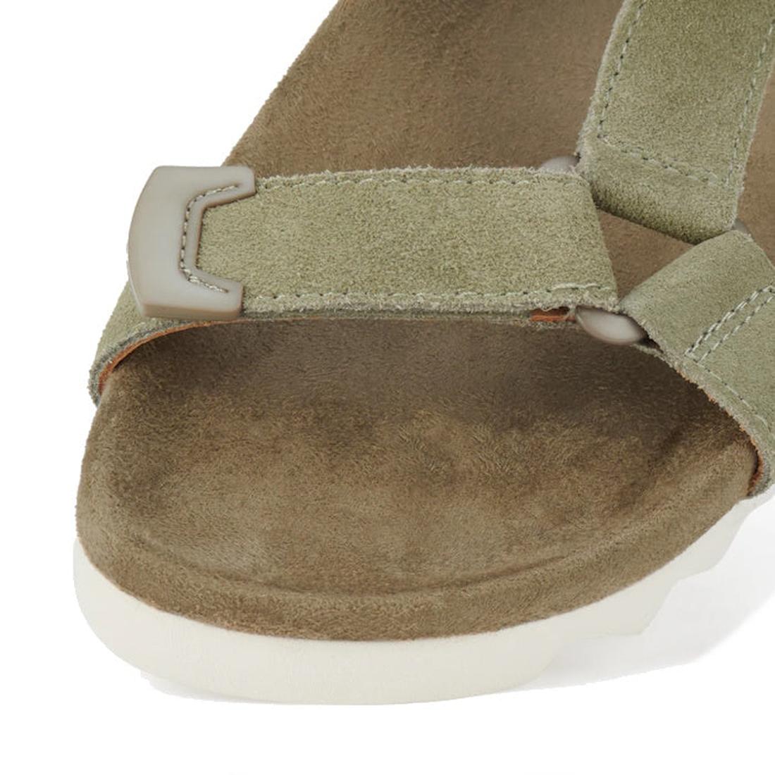 A close-up of the Rollie Womens Sandal Tooth Wedge Sage/White, featuring a light olive green suede strap, white EVA sawtooth wedge outsole, plastic buckle, and visible stitching for modern comfort and style., 48171, 9781760793883, 9781760793890, 978176079