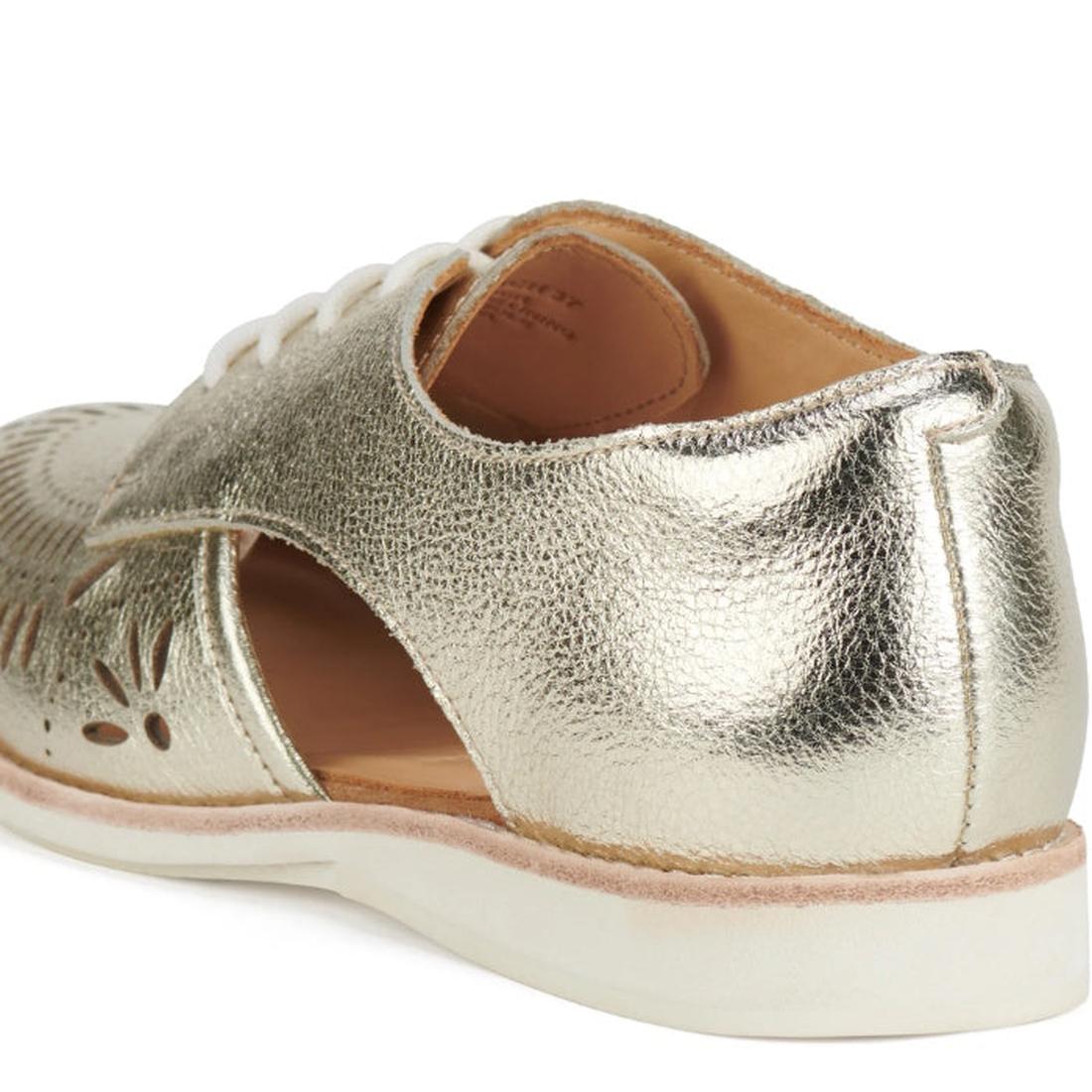 A close-up of the Rollie Womens Sidecut Boho Punch Gold Leather Shoe shows its metallic gold textured leather, floral cut-outs, white laces and sole, memory foam footbed, and a light tan inner lining for added comfort., 9381760798811, 9381760798828, 93817