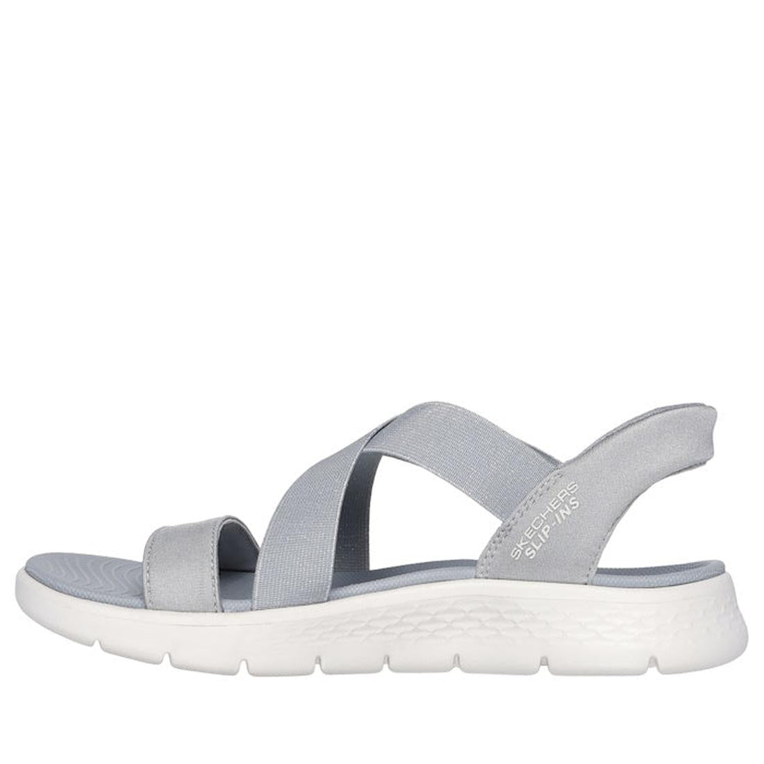 A light gray Skechers Womens Slip-Ins Go Walk Flex Glimmer Up Sandal with elastic crisscross straps and a white textured sole, shown in a left side profile against a white background., 41550, 41551, 197976616745, 41553, 197976616752, 41555, 197976616769, 