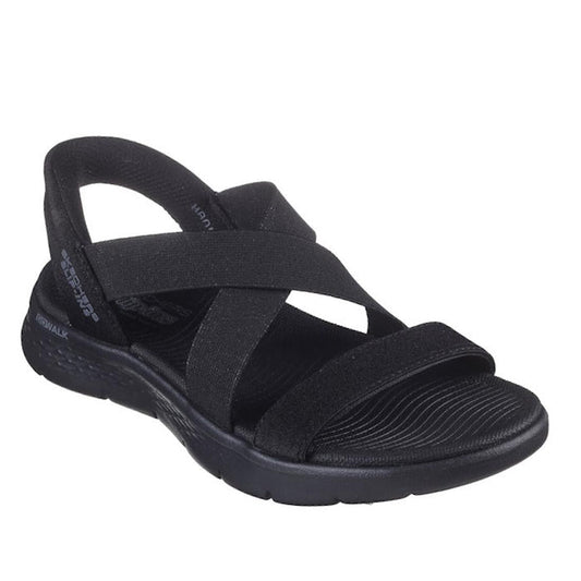 The Skechers Womens Slip Ins Sandals Go Walk Flex Glimmer Up Black features crisscross elastic straps, an open toe, cushioned sole, and textured footbed for comfort. Enjoy hands-free slip-in convenience and sporty style.