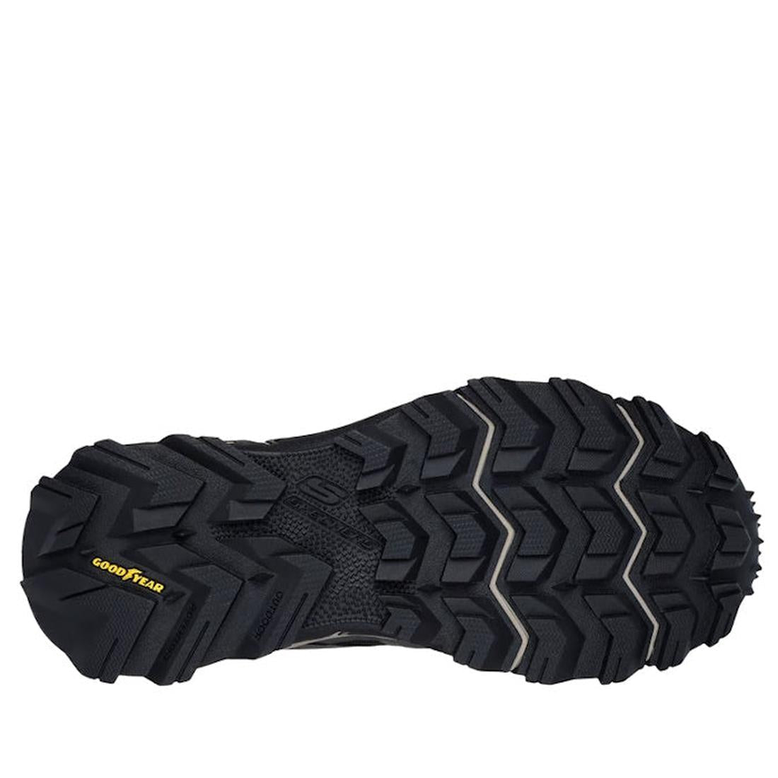 The image shows the black, rugged rubber outsole with deep, angular treads and a yellow Goodyear logo on the heel—built for grip and durability on the Skechers John Deere Equalizer 5.0 Trail Harvester Slip Ins in grey charcoal black., 50557, 50558, 197976
