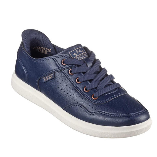 The Skechers Wide Width Bobs D'Vine So Flattered Navy Slip In Trainer is a navy blue slip-on sneaker with perforated details, navy laces, a white sole, HANDS FREE and BOUNCE SECURE labels, plus Skechers Memory Foam for comfort.