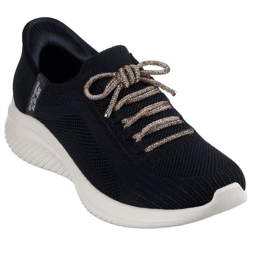 A black athletic sneaker with a white sole, woven fabric, glittery beige laces, and low-cut design. Side label: Skechers Womens Slip-ins Ultra Flex 3.0 - Diamond Dreamer Black Rose Gold; features Air-Cooled Memory Foam for comfort.