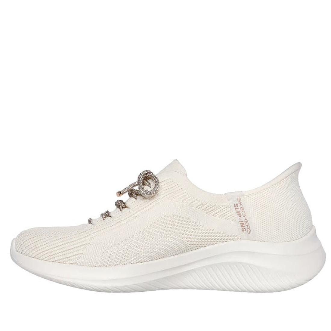 A side view of the Skechers Womens Slip-ins Ultra Flex 3.0 - Diamond Dreamer Natural Gold, showcasing a textured knit upper, decorative laces, thick curved sole, Hands Free Slip-ins design, Air-Cooled Memory Foam, and branding near the heel., 198376643225