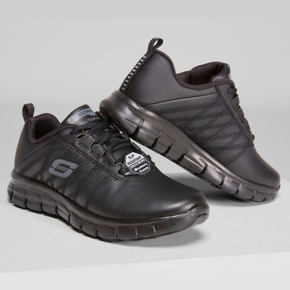 Pair of black leather Skechers lace-up work shoes with textured soles.