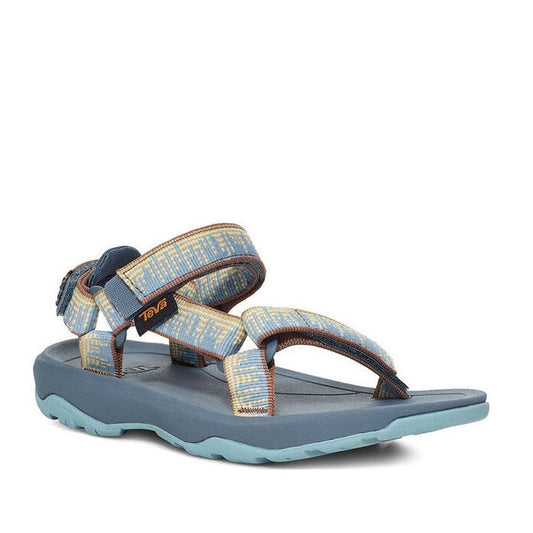 The Teva Kids Active Sandal K Hurricane XLT2 Blue has a blue sole, patterned recycled polyester straps in blue, yellow, and beige, hook-and-loop closure, and rugged tread—ideal comfortable hiking sandals.