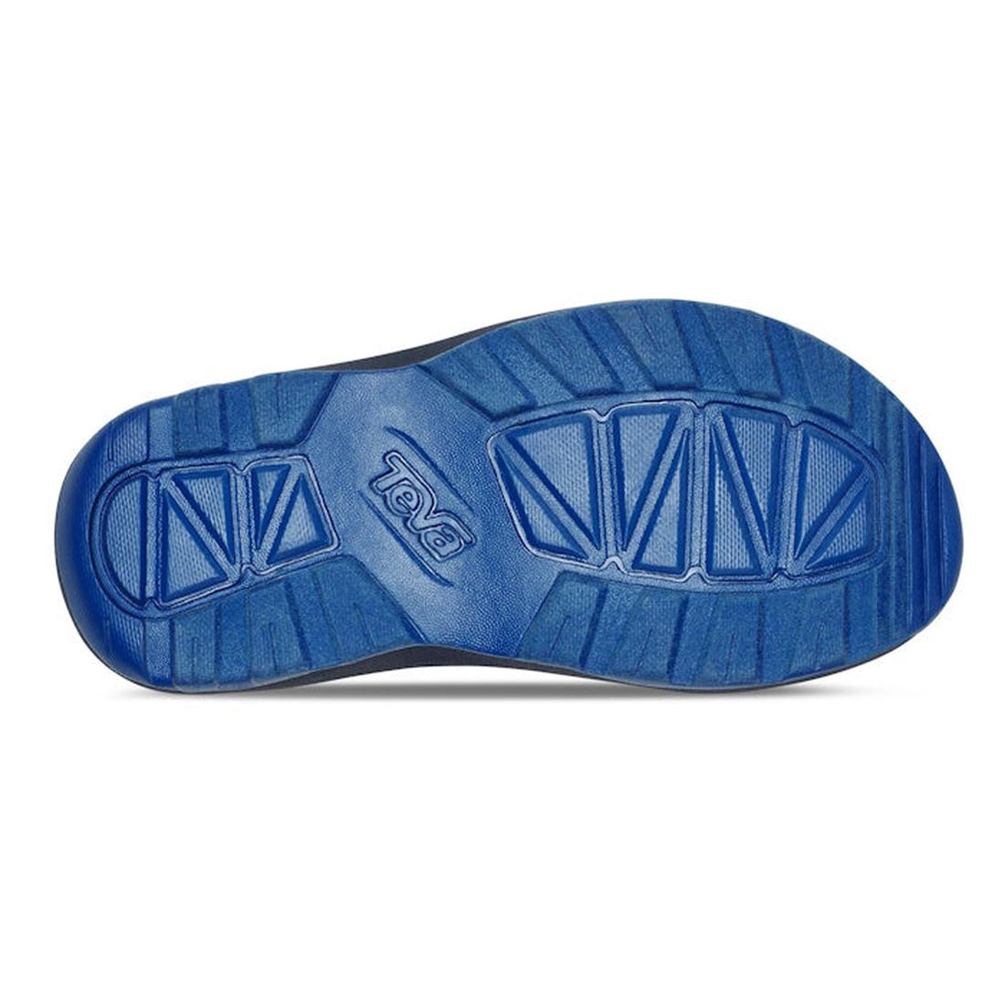 The image shows the blue rubber outsole of the Teva Kids - K Hurricane XLT2 Wave Mood Indigo vegan shoe, featuring textured tread patterns and the Teva logo embossed in the center., 196565099884, 196565099938, 196565099907, 196565099853, 196565099860, 196