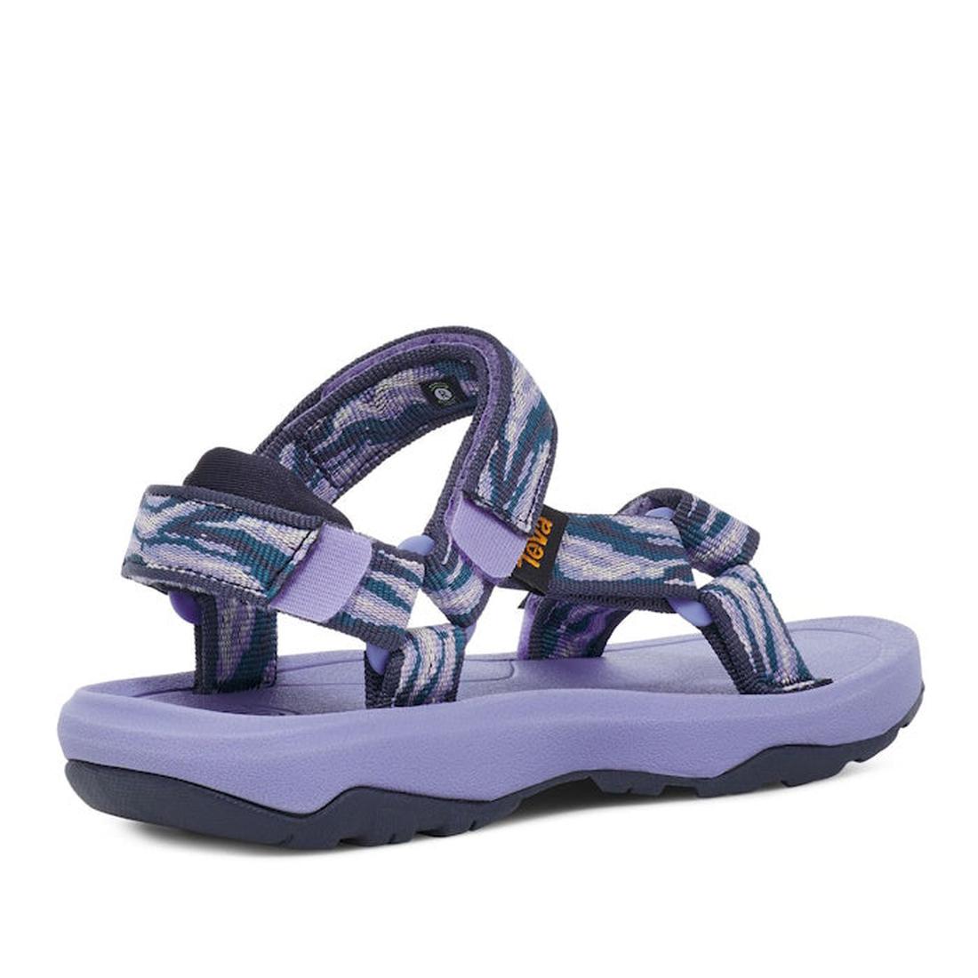 The Teva Kids K Hurricane XLT2 Waves Pastel Lilac Purple sandal features a purple sole, multi-colored blue, purple, and white recycled plastic straps, adjustable ankle and toe straps, and a rugged outsole for grip., 196565099822, 196565099839, 19656509978