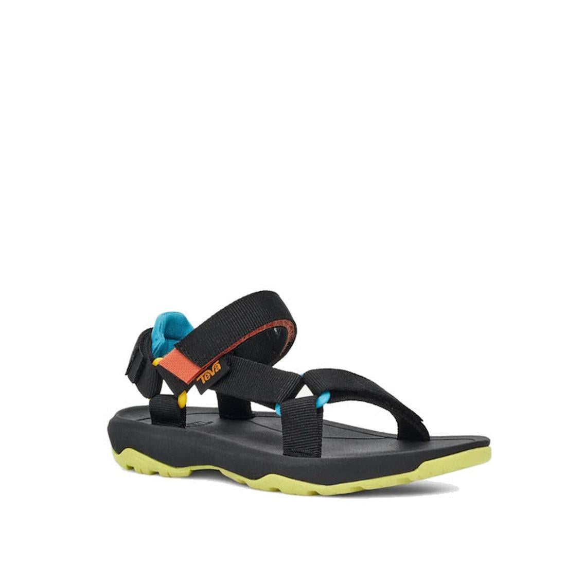 The Teva Kids K Hurricane XLT2 Black Multi is a black hiking sandal with adjustable straps, blue and orange ankle accents, and a yellow-green textured sole—crafted from recycled plastic and shown on a white background.