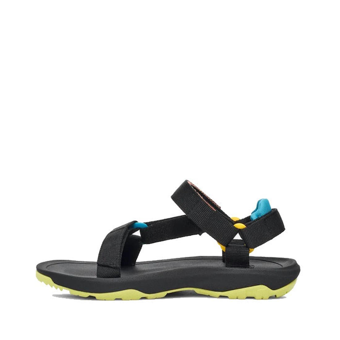 The Teva Kids - K Hurricane XLT2 Black Multi is a black hiking sandal with adjustable straps, cushioned black footbed, and bright yellow textured sole. Blue and yellow heel accents add style. Made with recycled plastic, shown in side profile on white., 19