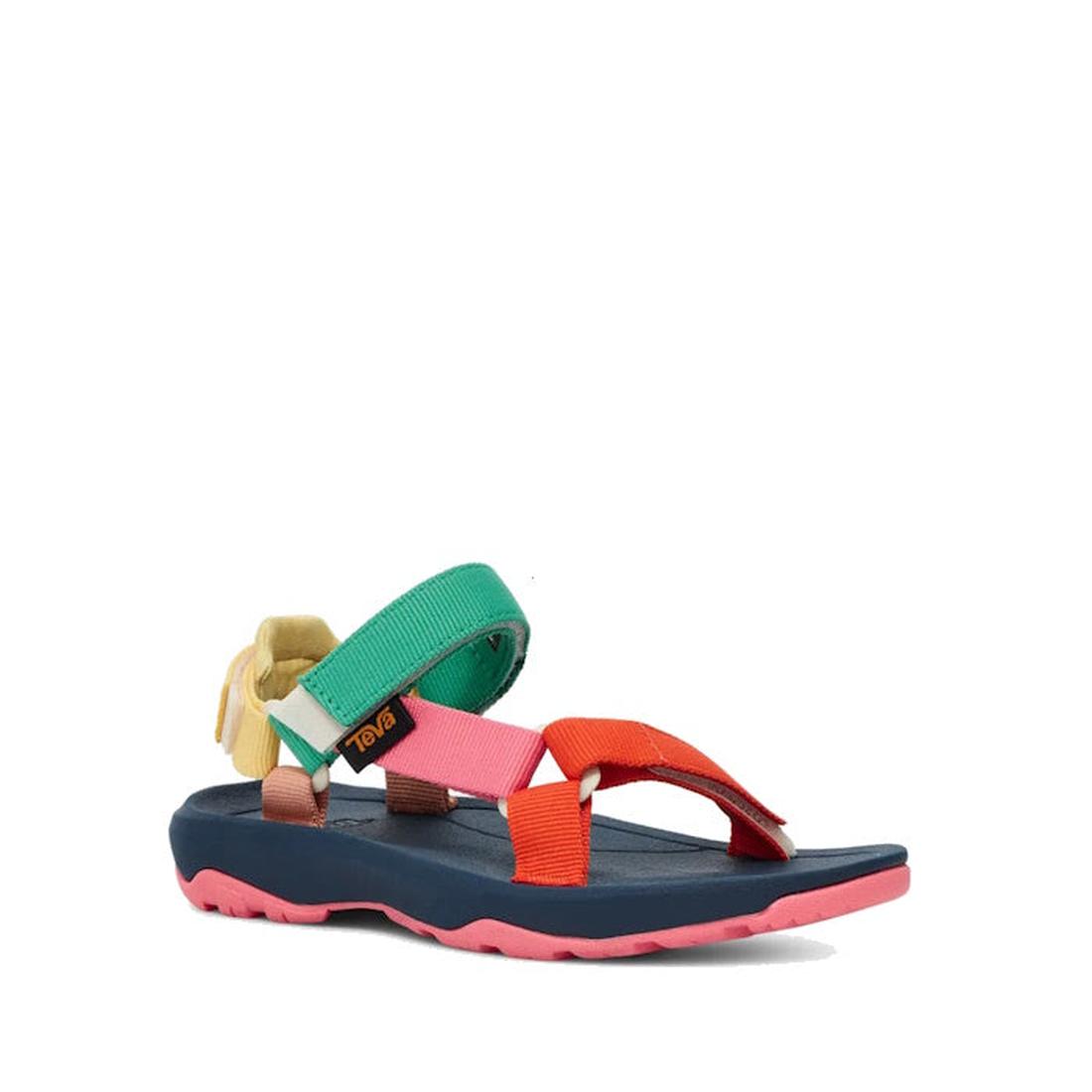 The Teva Kids K Hurricane XLT2 Popcorn Multi is a hiking sandal with a navy blue sole, pink tread, and multicolored straps in green, orange, yellow, and pink. Crafted from recycled materials and finished with a Teva logo on the side strap.