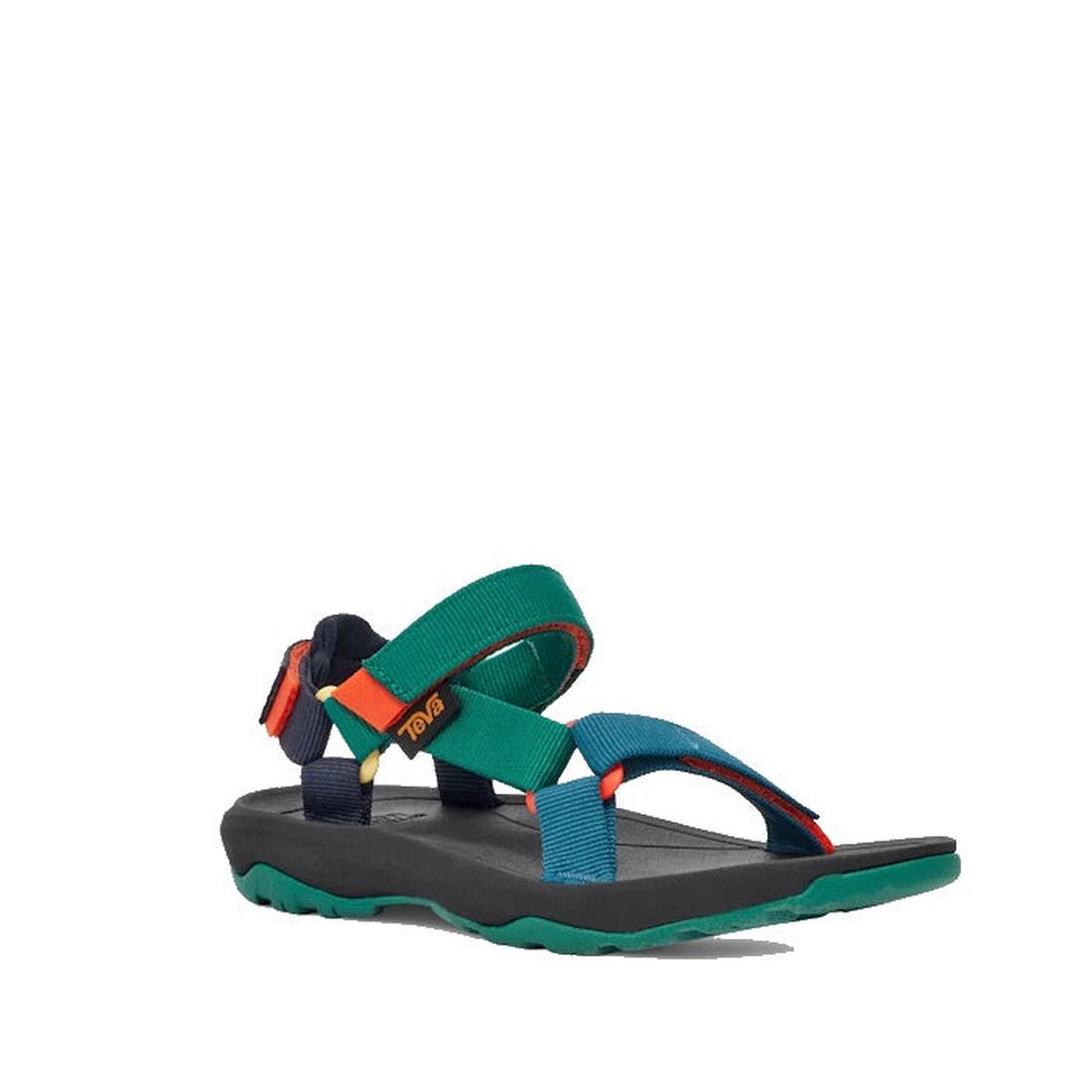 The Teva Kids K Hurricane XLT2 Black Teal Multi sandal features teal, green, red, yellow, and black recycled straps, an open toe design, and a thick black sole with green tread, shown on a plain white background.