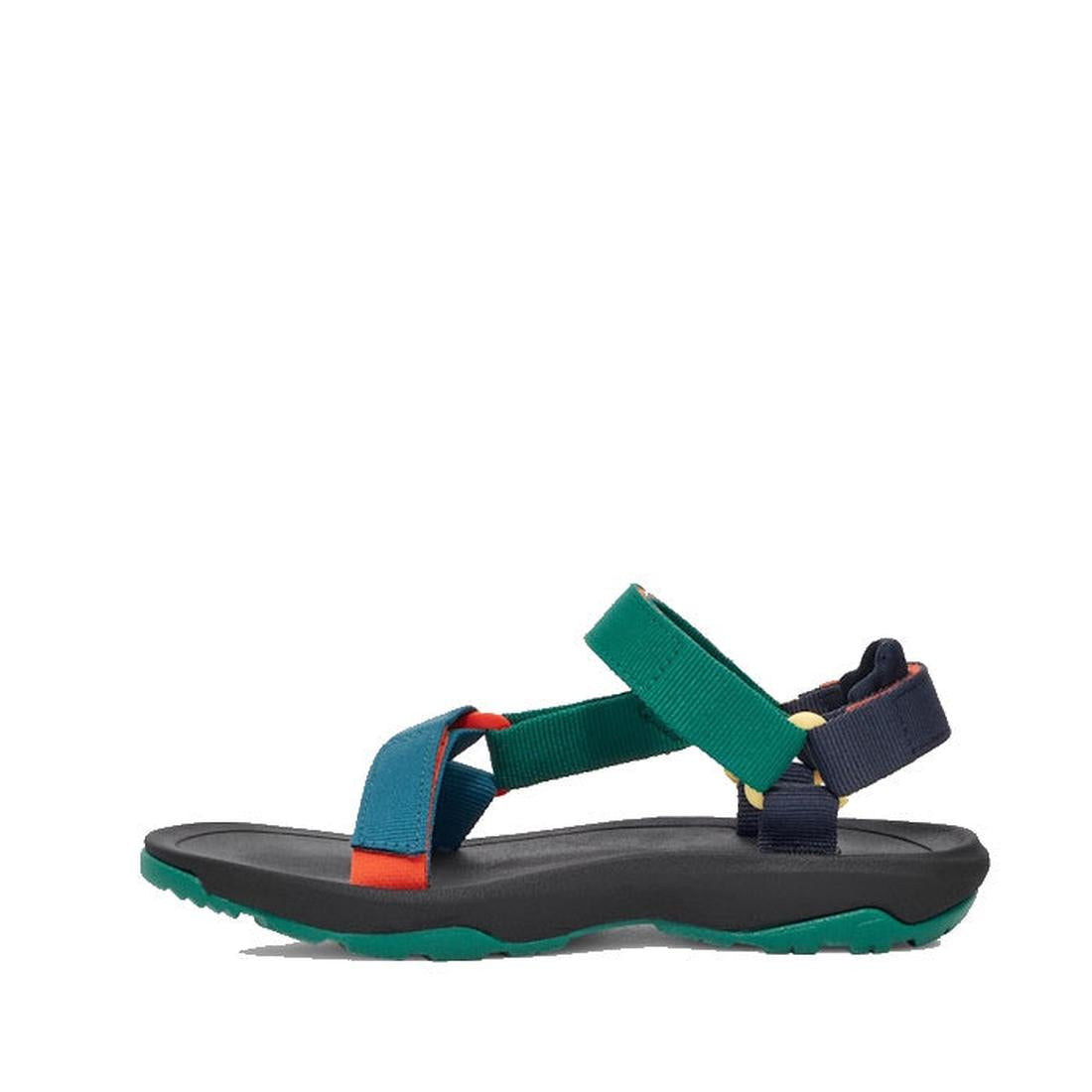 The Teva Kids K Hurricane XLT2 Black Teal Multi sandal features teal, green, navy, and orange recycled-material straps, a black cushioned sole, and a green textured outsole, shown in side profile on a white background., 196565921550, 196565921567, 1965659