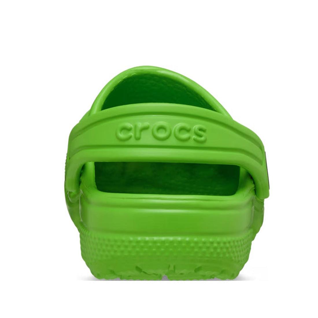 A Crocs Kids - Classic Clog Bright Green for juniors is shown from the back, highlighting the heel strap with "crocs" embossed and the textured sole. The water-friendly shoes are set against a plain white background., 49828, 49829, 49830, 49831, 49832, 49