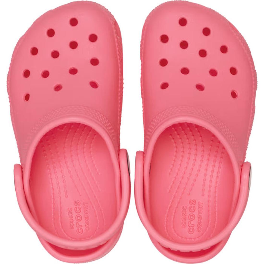 A pair of Crocs Kids Youths - Classic Clog K Guava Pink water-friendly clogs with ventilation holes and adjustable heel straps, viewed from above., 49837, 49838, 49839, 49840, 49841, 49842, 49843, 49844, 49845, 198445337710, 198445337727, 198445337734, 19