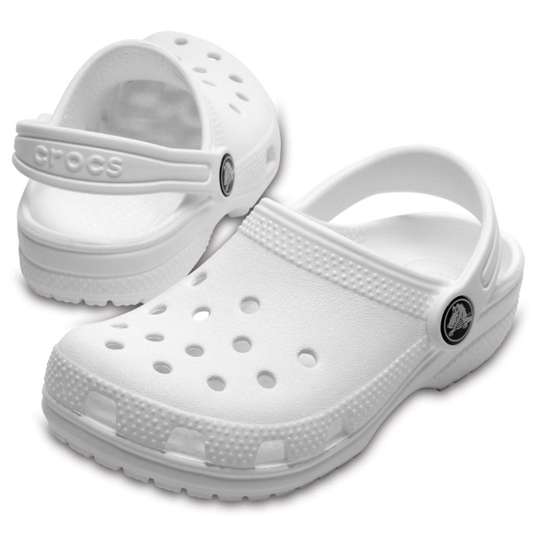 The Crocs Kids - Youths Classic Clog K White Sandals feature ventilation holes and adjustable heel straps, ideal as water-friendly youth sandals with one shoe facing forward and the other displaying the back.