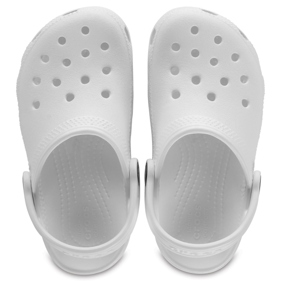 A pair of Crocs Kids - Youths Classic Clog K White Sandals seen from above, showing perforated uppers, textured footbeds, and adjustable heel straps—water-friendly and ideal for everyday comfort., 191448734555, 191448734562, 191448734579, 191448734586, 19
