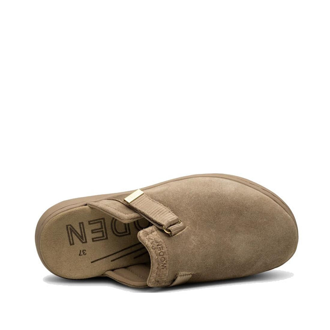 The Woden Womens Vega Clog Suede Mule in Silver Mink (Beige) features a tan suede upper, rounded toe, gold buckle detail, and “MODERN” printed on the insole. It includes Natural Soft Technology and is shown from an angled overhead view., 42722, 5713326514