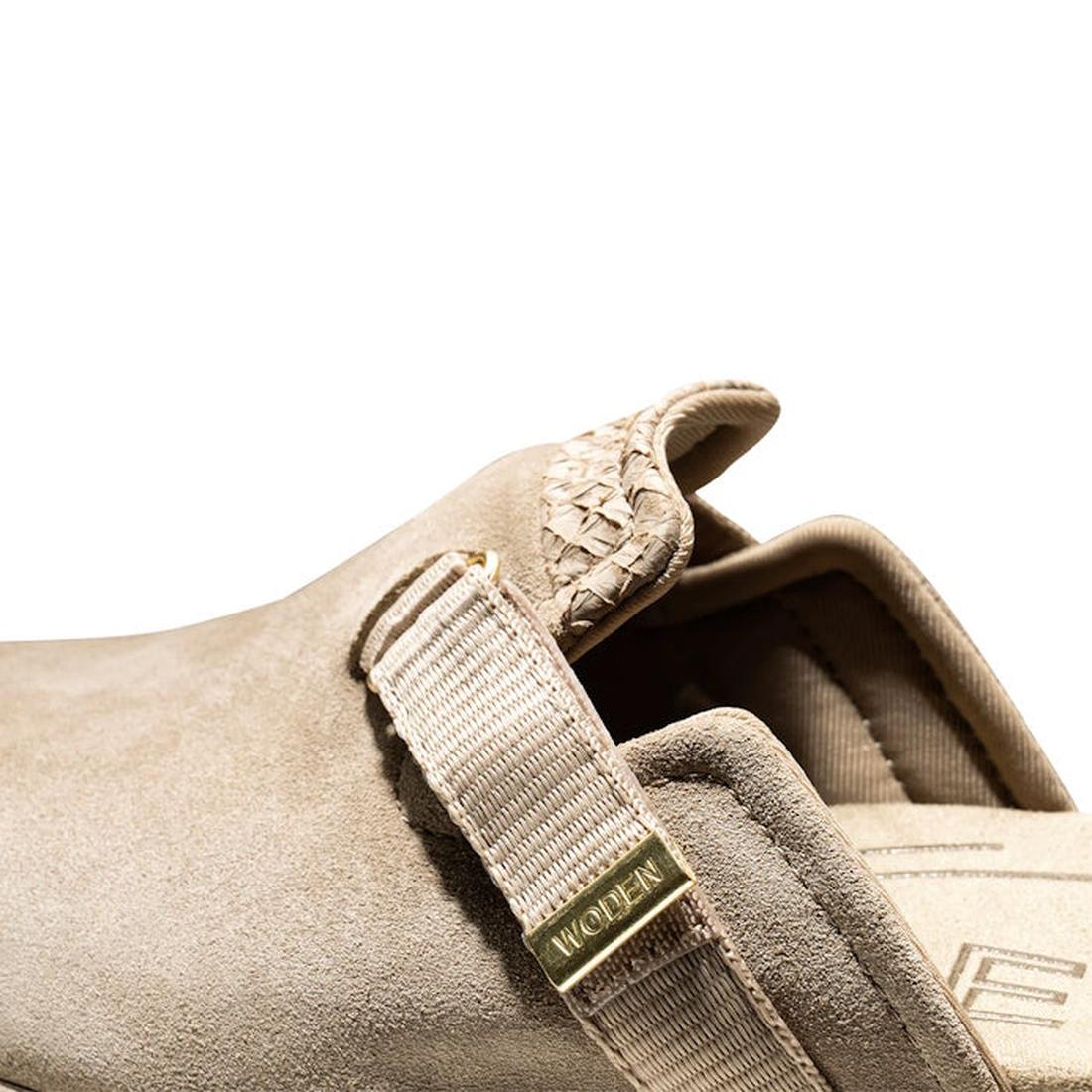 Close-up of the Woden Womens Vega Clog Suede Mule in Silver Mink Beige showing a textured band, woven tongue detail, beige strap with gold WOOLEN tag, and Natural Soft Technology. Set against a white background., 42722, 5713326514100, 5713326514117, 57133