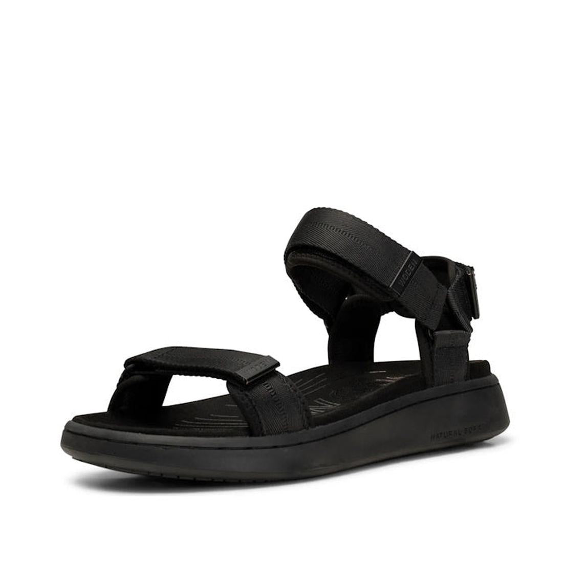 The Woden Line Women's 3 Strap Sandal in Black features adjustable toe and ankle straps, a cushioned sole with Natural Soft technology, and a slight heel—perfect for all-day comfort and sporty style.