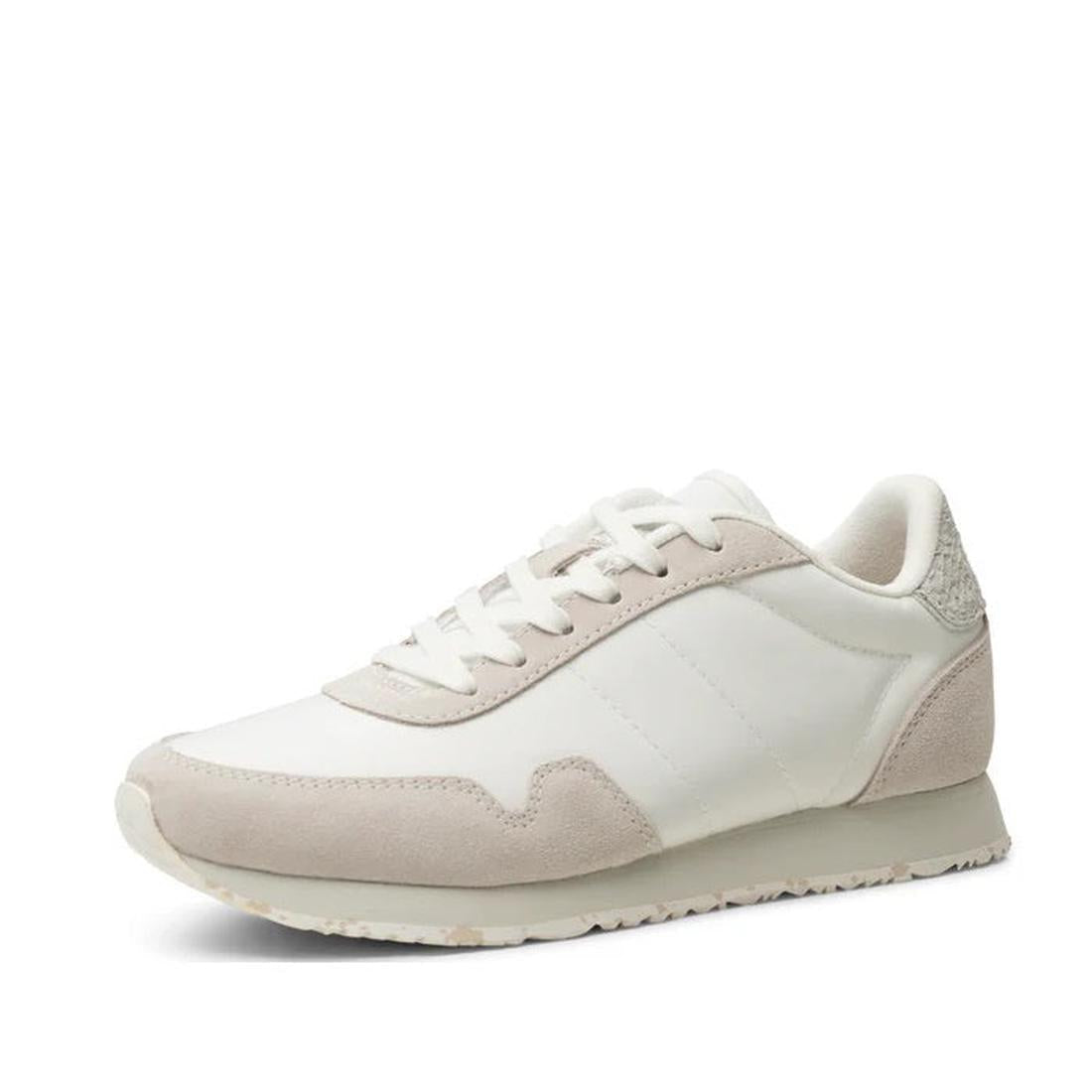 The Woden Womens Sneaker Nora III Nylon/Leather in Blanc de Blanc features a low profile, lace-up closure, suede accents, and textured sole—stylish urban footwear shown on a plain white background.