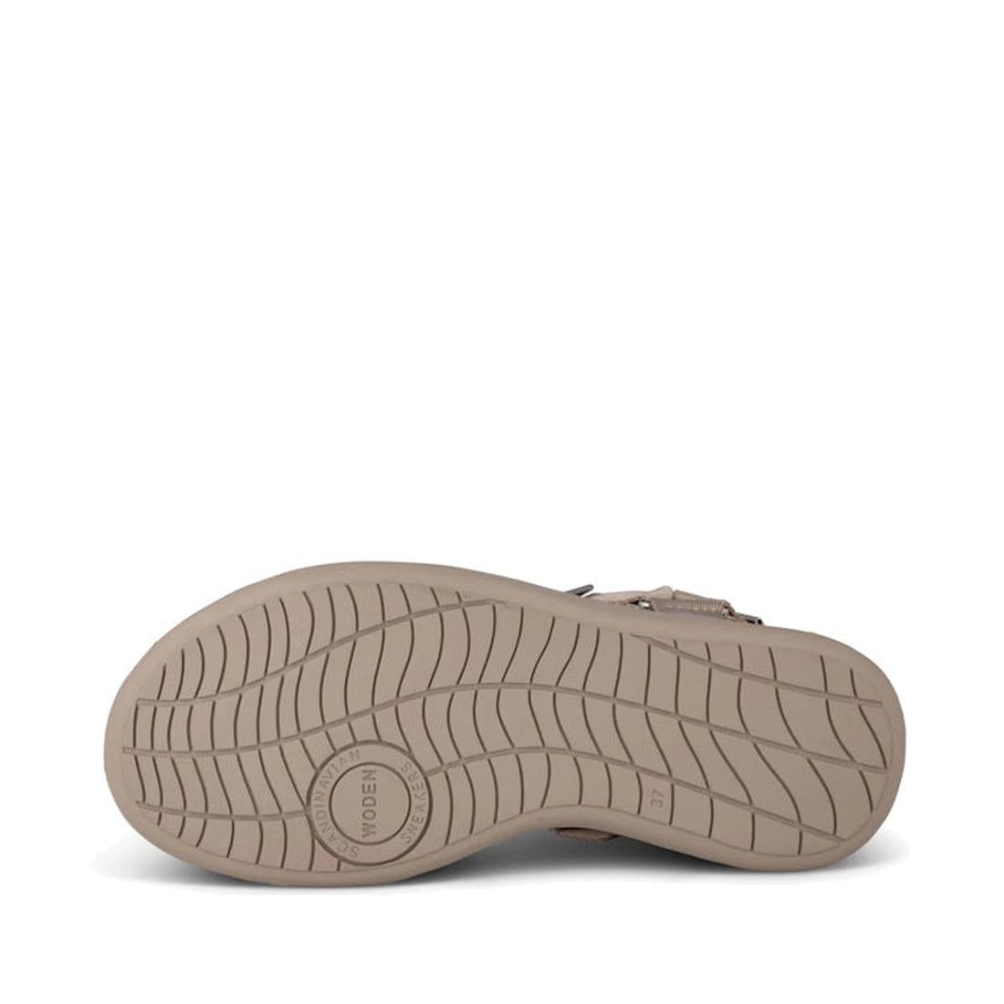 The image shows the bottom view of the Woden Line Women's 3 Strap Sandal in Silver Mink, featuring beige color, textured anti-slip grooves, and a circular WODEN logo near the heel., 48203, 48204, 5713326605235, 5713326605242, 5713326605259, 5713326605266,