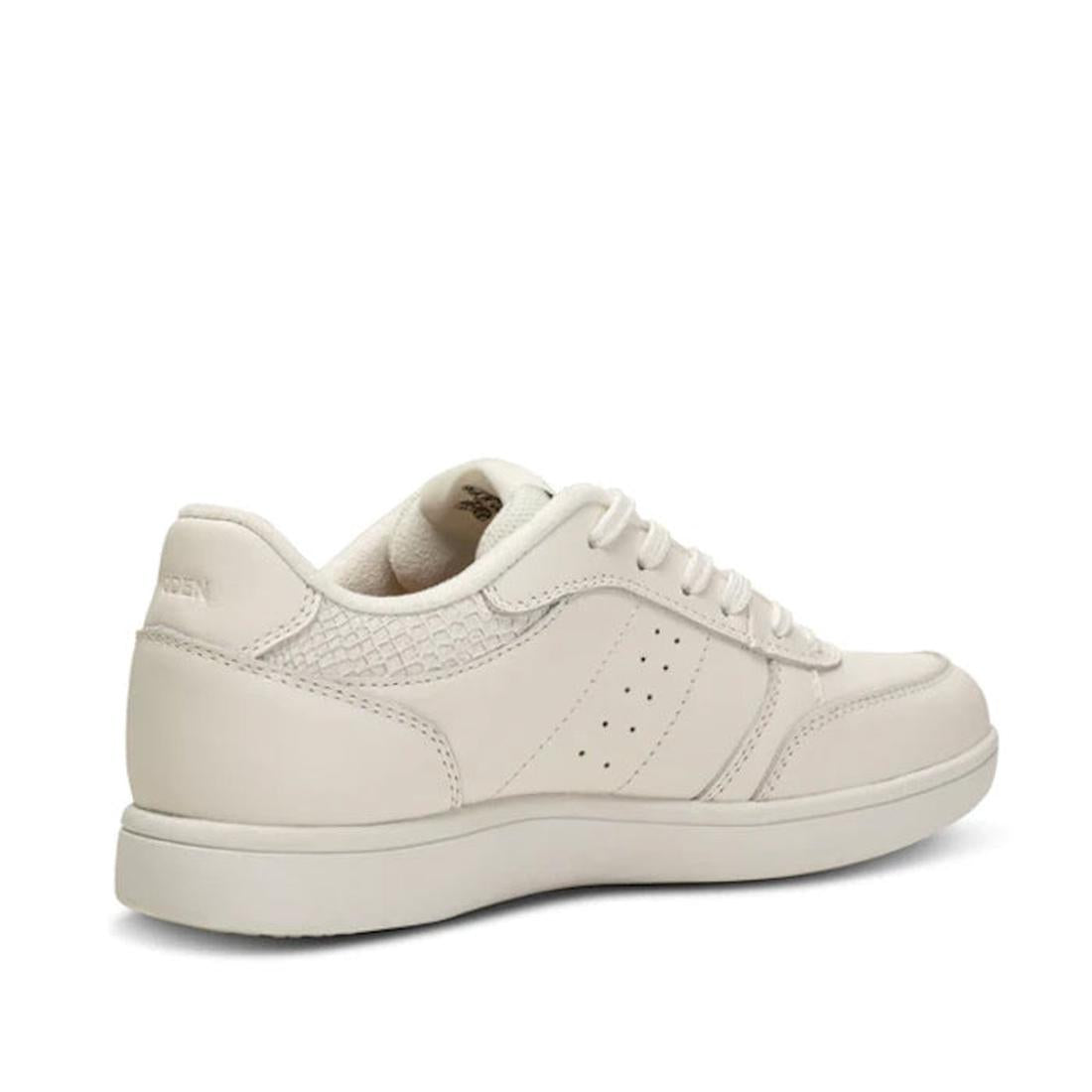 The Woden Bjork Women's Leather Sneaker in Blanc de Blanc White showcases sustainable fish leather, a textured heel, perforated sides, and a low-profile sole, displayed at an angled back and side view on a white background., 5713326460865, 5713326460872, 