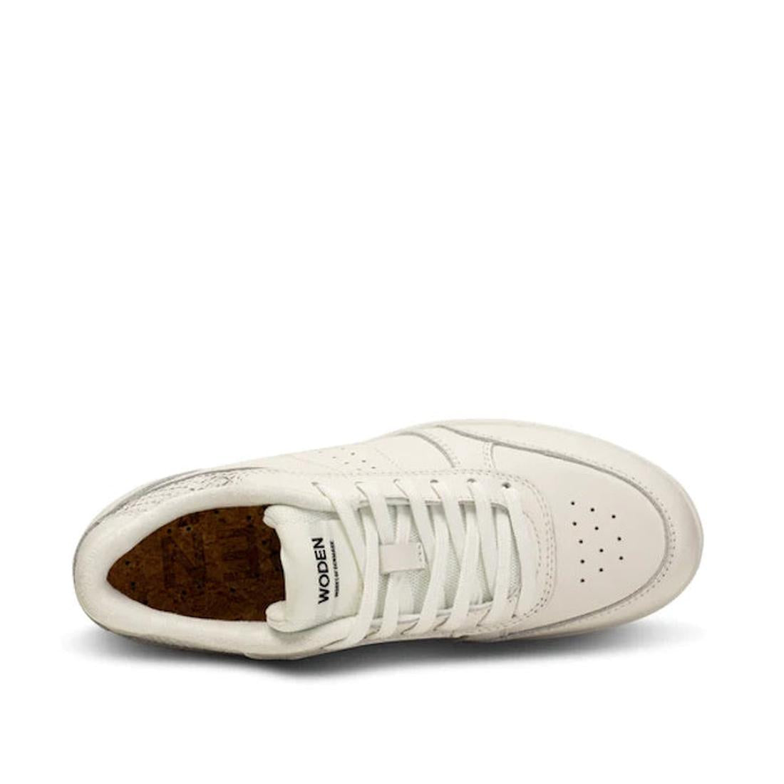 Top view of the Woden Bjork Women's Leather Sneaker in Blanc de Blanc White, featuring white laces, perforated toe box, cork insole, fish leather accents, and visible WODEN branding on the tongue against a plain white background., 5713326460865, 571332646