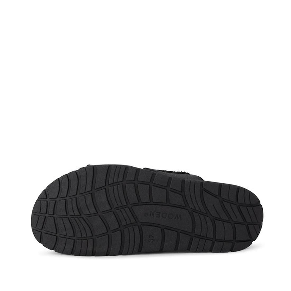 The Woden Lisa Women's Leather 2 Strap Sandal Black features a black rubber sole with wavy tread patterns, embossed "47" and "WODEN" at the center, an anatomically shaped footbed, displayed on a plain white background., 5713326518276, 5713326518283, 57133