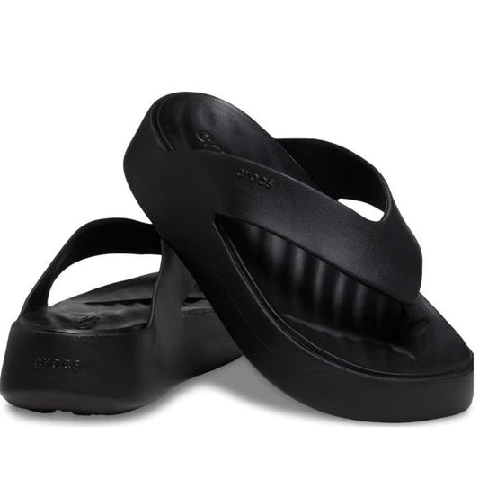 A pair of black Crocs - Womens Getaway PLATFORM Flip Sandals—one upright, one on its side—showcasing the thick sole, wide strap, and cushioned footbed with Free Feel Technology for all-day comfort.