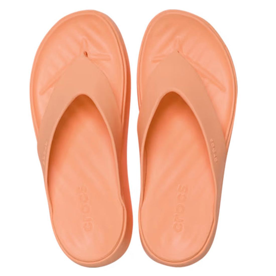 The Crocs Womens Getaway PLATFORM Flip Sandal in Sunstone Orange features wide straps, cushioned soles with Free Feel Technology, and a platform jandal style, shown here as a peach-colored slip-on viewed from above., 49910, 49911, 198445274329, 1984452743
