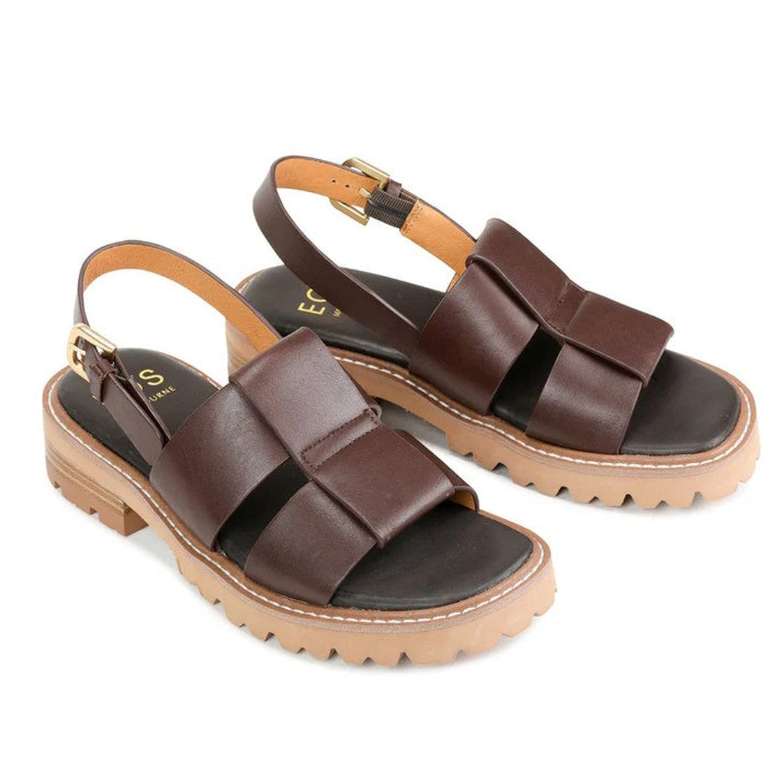 The EOS Womens Leonella Dark Brown Sandal with Back Strap features wide crisscross straps, tan ankle buckles, and thick tan rubber soles with ridged treads, displayed on a white background., 40427, 9321191223438, 9321191223445, 9321191223452, 932119122346