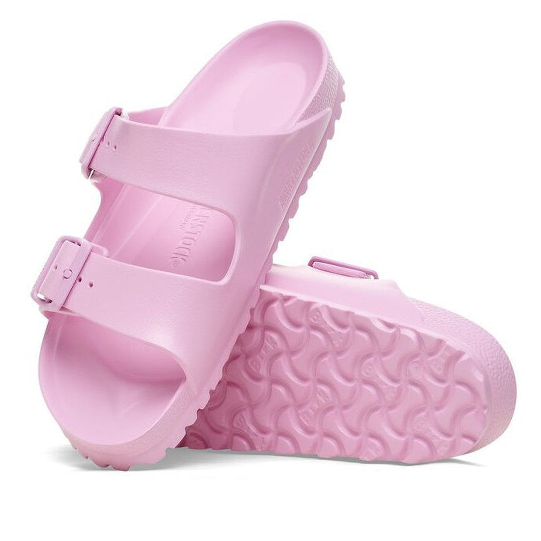 a pair of Birkenstock Arizona EVA Fondant Pink Narrow Width with double straps, one over the foot and one over the toes with buckle adjustment. Staps are linked at the sides of the foot. Made of EVA a plastic like material, suitable fot being around water