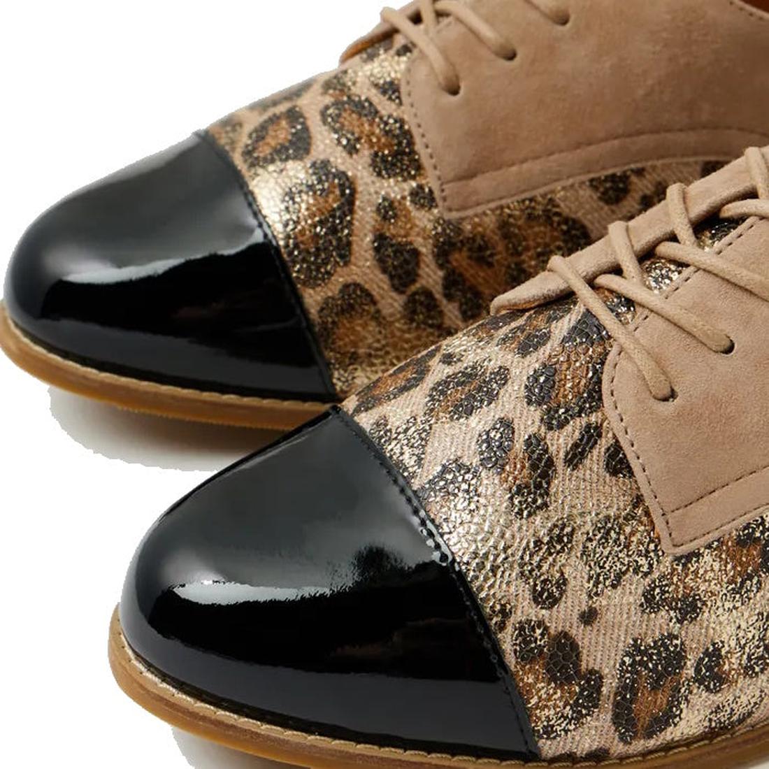 Close-up of the Ziera Tobin XF Women's Flat Brogue in Black Taupe Leopard, showcasing glossy black cap toes, leopard print sides with metallic sheen, tan suede uppers, and a removable comfort plus footbed on a white background., 51040, 4434755462978, 4434