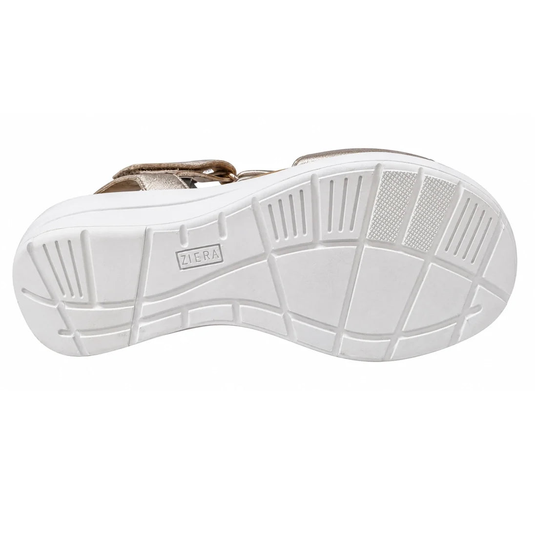 The image displays the white grooved sole of the Ziera Nazly2 Platino Gold White XW Womens Leather Sandal, viewed from underneath to highlight its tread pattern and the embossed Ziera branding at the center. This distinctive sole design offers excellent t