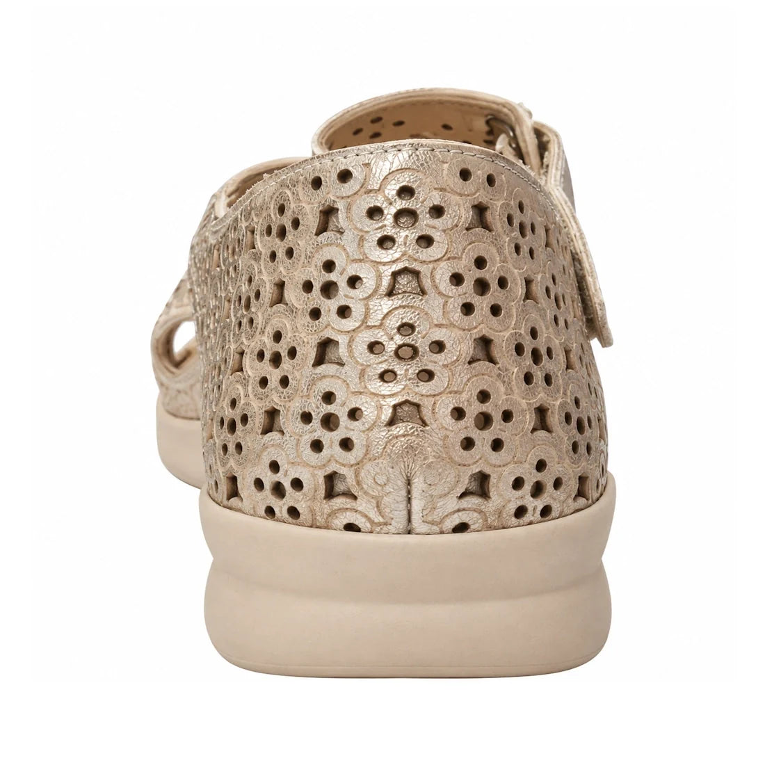 A close-up of the back of the Ziera Bizza Pale Gold XW Women’s Leather Sandal, featuring a floral cut-out pattern on beige leather with a flat sole and extra wide fit comfort, shown against a white background.